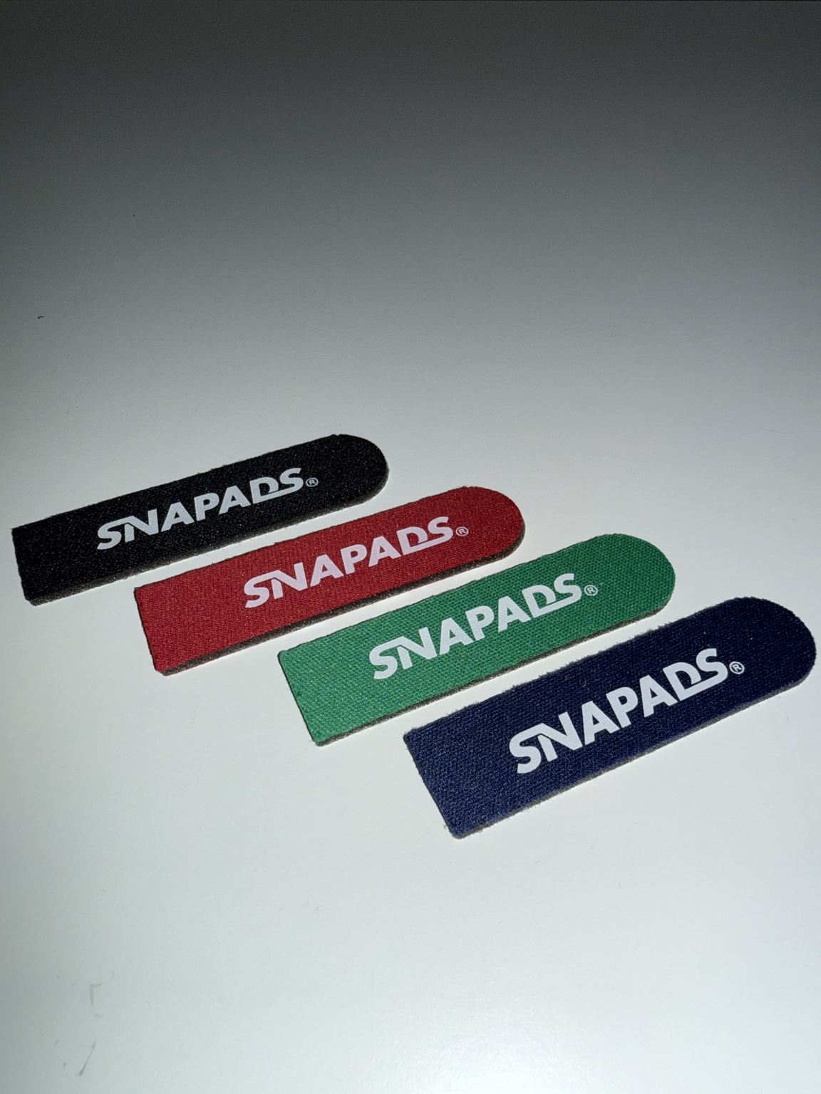 Green SnaPads installed on a snapback